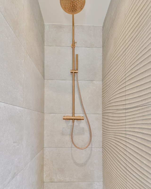 Secaucus, NJ small shower renovation featuring simple tan tile.