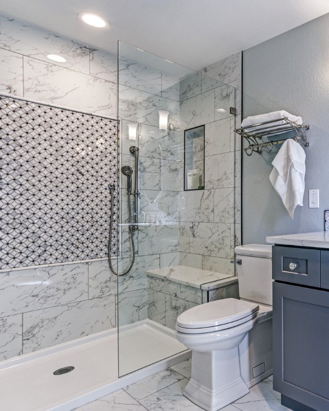 A tub-to-shower conversion in Hoboken, NJ featuring a frameless glass shower and elegant marble tile.