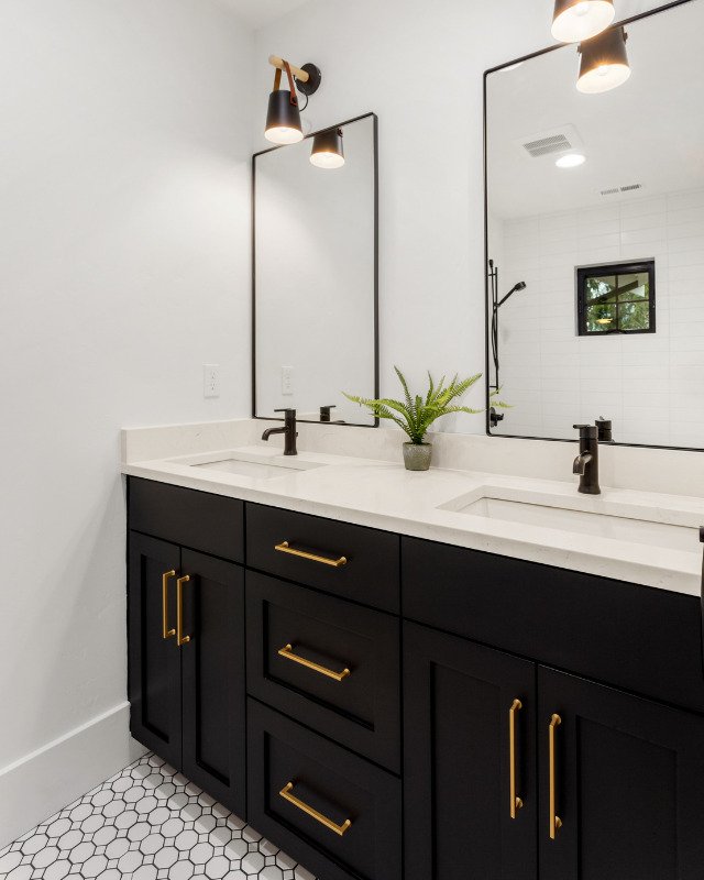 A sumptuous bathroom interior in a luxury apartment in Hoboken, NJ, adorned with a dark-colored vanity, a resplendent mirror, and opulent cabinets, exuding an aura of sophistication and timeless elegance, a testament to the masterful design by Hoboken Bathroom Renovation.