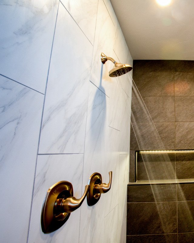 Bathroom remodel in Secaucus, NJ featuring luxury shower fixtures and marble tile.