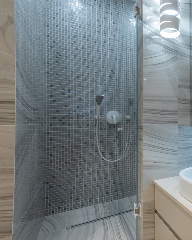 Spa-inspired bathroom remodel in Weehawken, NJ featuring a tile shower backsplash.