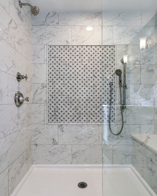 A modern custom shower enclosure with rainfall showerhead and elegant tile work, a testament to the craftsmanship of Hoboken Bathroom Renovation in Hoboken, NJ.