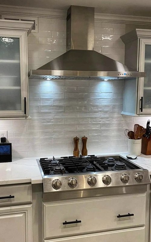 A kitchen in Hoboken, NJ, adorned with a classic subway tile backsplash, seamlessly blending functionality with timeless elegance, creating a heartwarming and inviting ambiance, a reflection of the impeccable taste and craftsmanship of Hoboken Bathroom Renovation.